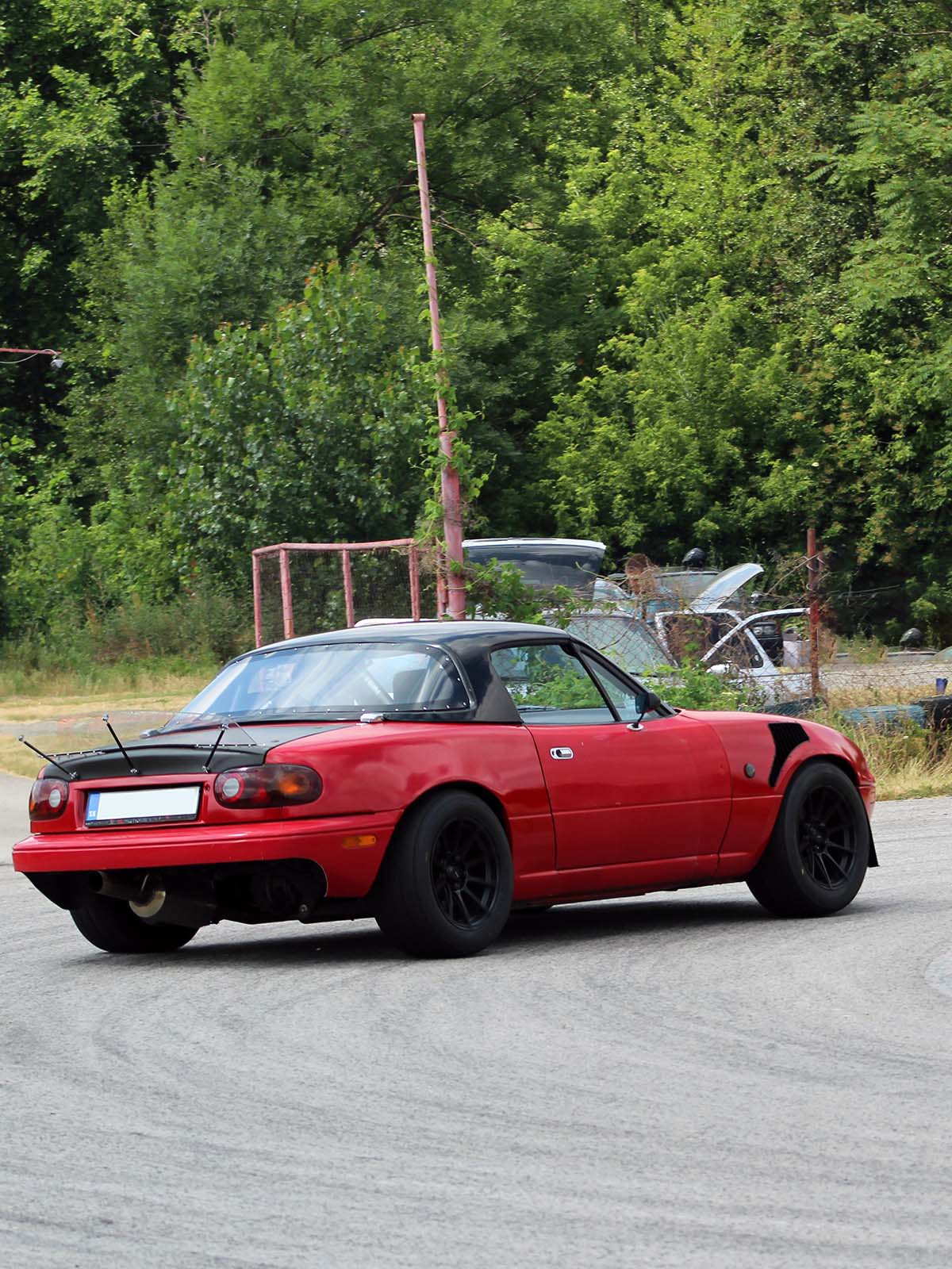 red miata drifting with lexan spoiler installed. picture is to show how the spoiler looks installed on car.